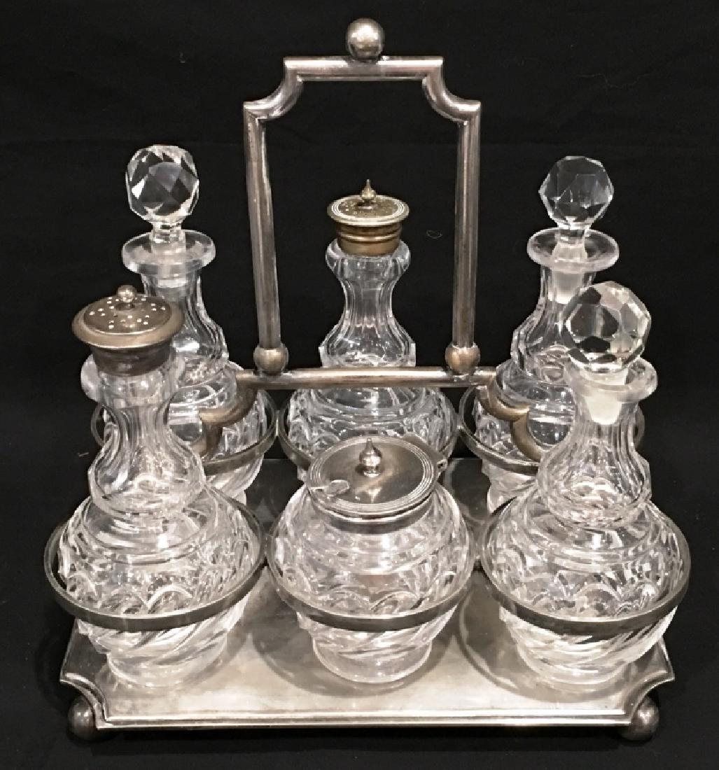 6 PC CONDIMENT SET BY T W & S: SILVER, THREE BOTTLES WITH GLASS STOPPERS AND THREE WITH SILVER TOPS, MARKED TW&S ON BOTTOM, 9.5" TALL X 9" WIDE