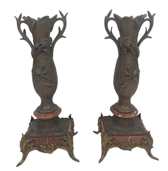 Pair Bronze Double Handled Urns: Total design is floral in nature, sitting on red marble base upon four feet, 8 inches in diameter, 18.5 inches in height, one back foot is missing half of foot