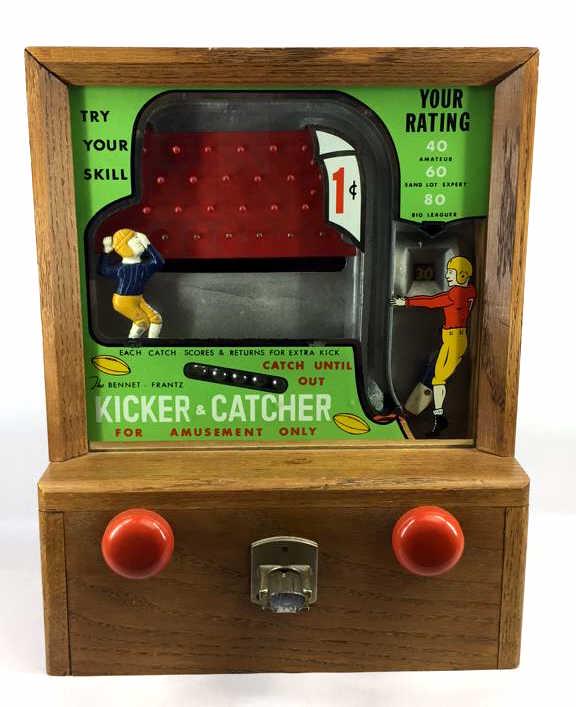 Antique Bennet-Frantz Kicker And Catcher Game: Circa 1950’s, This football theme countertop amusement game has the player use one knob to kick a ball into the pin field and another to catch it. Machine is in wood case, in original condition with
