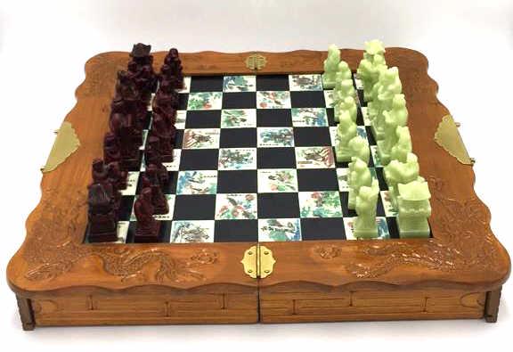 Ornate Oriental Chess Set: Engraved and colored white bone spaces, pieces seem to be resin mix, board has storage for pieces underneath and folds in half, measures 18.75 inches by 18.75 inches, see photo