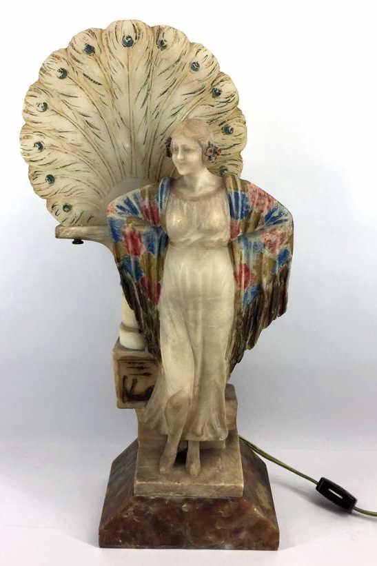 Art Nouveau Carved Alabaster Figural Table Lamp: Circa 1920, Carved as a young woman standing by a plinth with peacock feathers fan, Handpainted, measures 16.25 inches by 8.5 inches by 6 inches, excellent condition, see photo