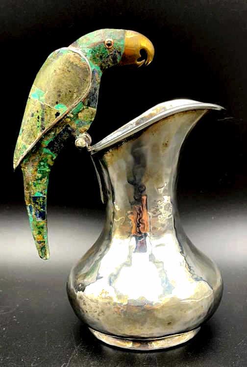 Los Castillo Hammered Silver Plate Parrot Pitcher: Hammered silver plate pitcher with azurite and malachite inlay parrot handle created by the Los Castillo workshop, Taxco, Mexico circa 1960s. Pitcher measures 7 inches by 5, signed Los Castillo, Taxco