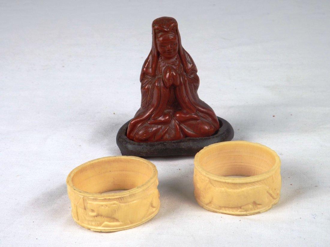 Bone napkin ring set with oriental figurine: Bone pair of napkin rings (African), and a figurine with a custom stand