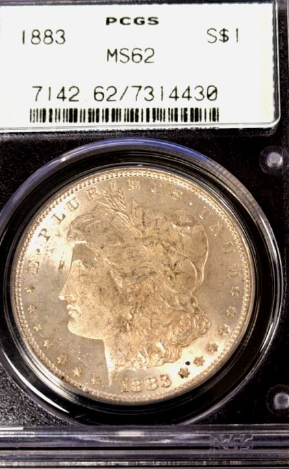 1883 Morgan Silver Dollar Coin: Graded MS-62 by PCGS, slabbed coin, see photos