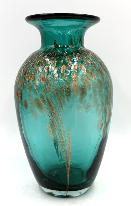 Emerald Green Art Glass Vase with Gold Aventurine: An emerald green glass vase features a wide neck, a dark rim, and an internal decorative pattern of metallic gold or copper aventurine flecks, with no visible identifying marks, it is 10 inches tall a
