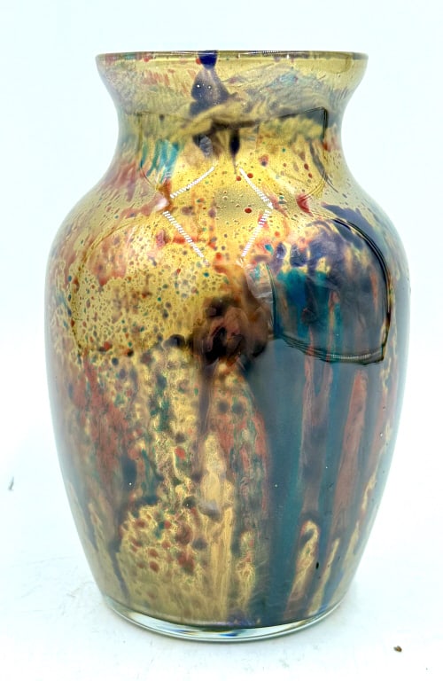 Iridescent Art Glass Vase Gold Blue Red Green: An iridescent art glass vase, primarily gold with speckled and streaked designs in blue, red, and green colors, and having no visible marks or inscriptions, it is 7 inches tall and 4.75 inches across,