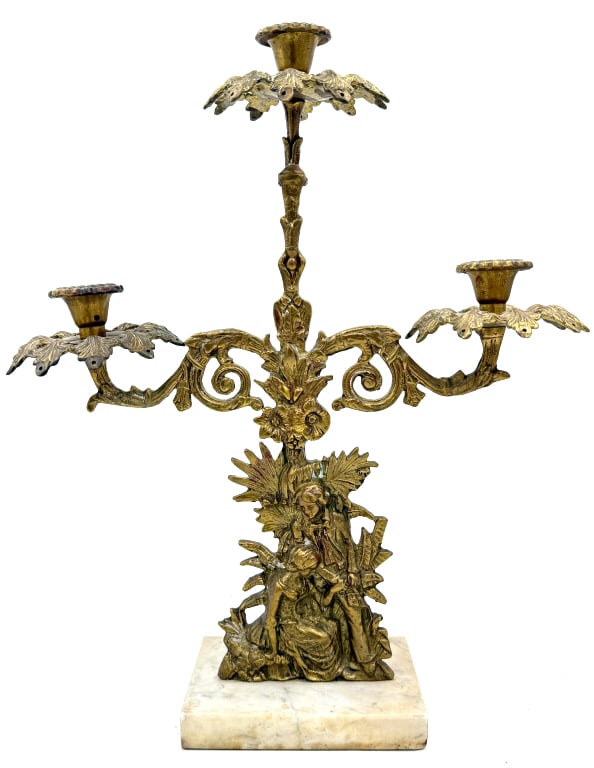 Figural Girandole Candelabra: A single gold-toned metal, three-light Girandole candelabra featuring highly ornate scrollwork and a central figural scene, mounted atop a square white and beige marble base, it is 7.5 inches tall and