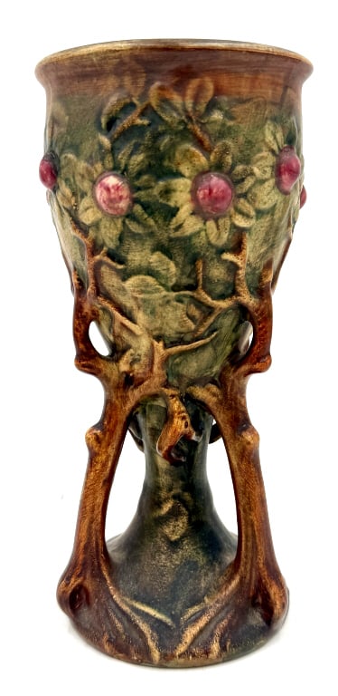 Weller Woodcraft Ceramic Pedestal Chalice Vase: A single ceramic pedestal vase by Weller, featuring the Woodcraft pattern with molded tree branches, green and brown foliage, and red fruit, impressed WELLLER on the base, it is 9.25 inches tall and 4