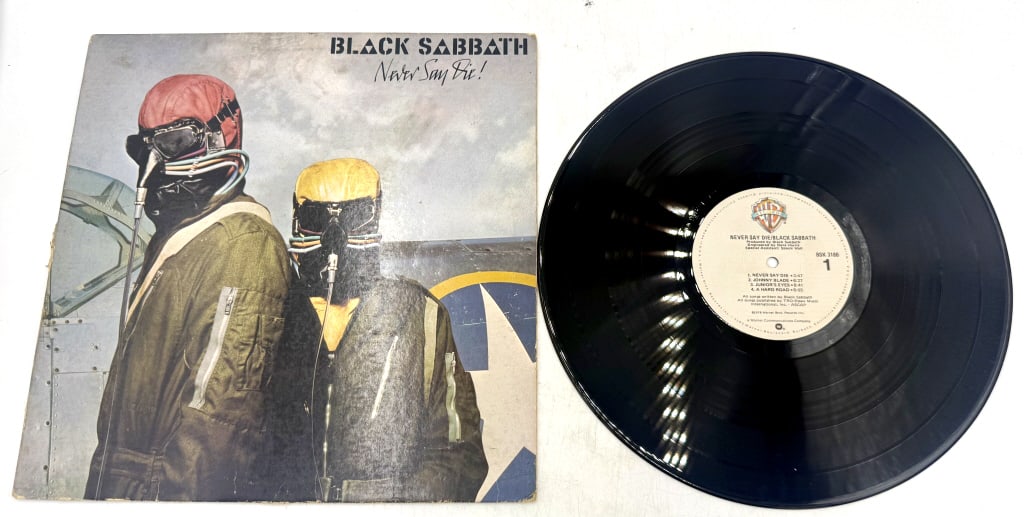 Black Sabbath Never Say Die! Vinyl LP Record BSK: A black vinyl LP record and sleeve for the Black Sabbath album Never Say Die!, featuring the Warner Bros. Records catalog number BSK 3186 and runout groove identifiers SK-1-3186 and SK-2-3186.