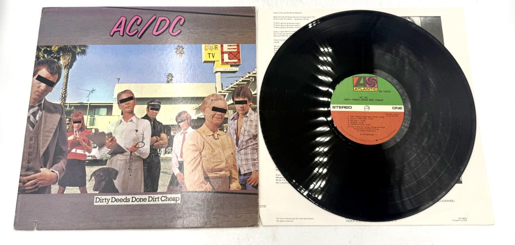 AC/DC Dirty Deeds Done Dirt Cheap Atlantic Vinyl: A black vinyl record album and gatefold sleeve titled "Dirty Deeds Done Dirt Cheap" by AC/DC, featuring ATLANTIC branding and catalog number SD 16033, inscribed "? 1976 Atlantic Records" on the center