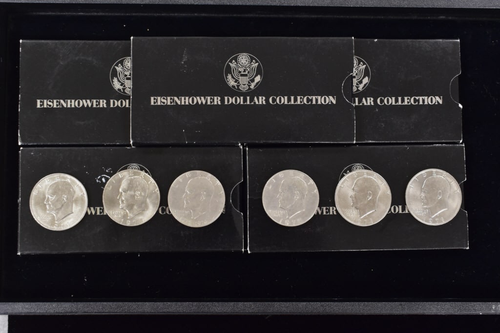 Lot of 16 Total Ike Dollar Coins: 6 raw coins and a total of 10 in cases, please see photos.
