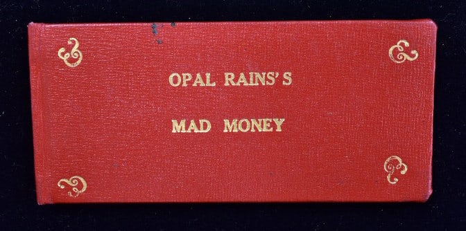 Opal Rains?s Mad Money Personal Book: Regular use, emergency fund book, 23 $1 bills inside, please see photos.