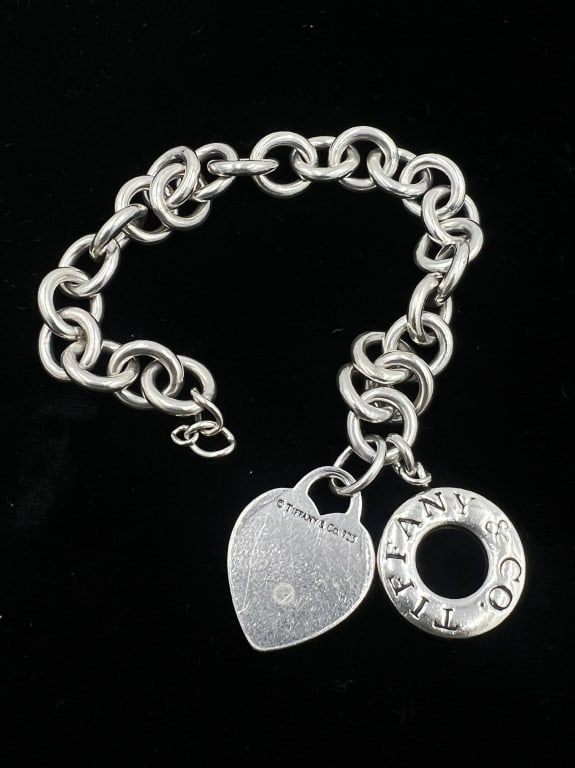 SS Tiffany Charm Bracelet: 7 inches, comes with two charms, and missing clasp. Total weight 41 grams, See photos
