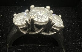 Three-Stone Diamond Engagement Ring: The center stone is between 1.25 and 1.5 carat with two side stones are between .55 and .75 carat, Center stone is believed to be G-H color, and VS2, Total weight 6.5 grams, See photos