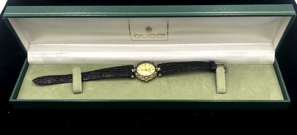 Gucci Two-Toned Ladies Quartz Watch: Uses stainless steel and is gold plated. Comes with original box. Untested, may need new battery. See photos