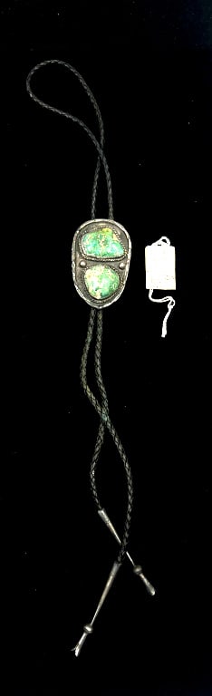 Navajo Silver Turquoise Bolo Tie: 20 inch length, turquoise stones set in bezel settings, braided black leather cord, and silver aglet tips. Tag with tie states it belonged to J. Vandever, a WWII Navajo CodeTalker.