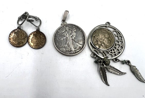 Assorted Coin Jewelry: 1947 Walking Liberty Half Dollar Pendant, Buffalo Nickel(no year visible) Dream Catcher, and 2 Sterling Silver Earrings styled as 1888 Morgan Silver dollars. See photos