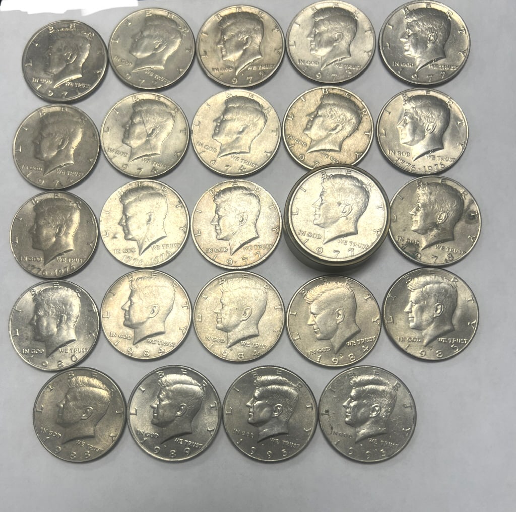24 - Kennedy Half Dollars 1971-1995: Years Ranging from 1971-1995. One coin set in a brass/metal stand.