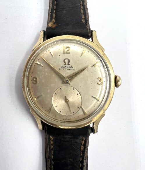 1950?s Omega Wrist Watch: 14k gold filled case, automatic bumper, in working condition, band needs to be replaced.