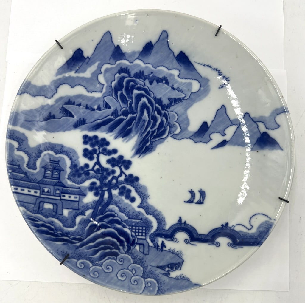Japanese Imari Landscape Plate: 9.87x1.5 inches, underglaze cobalt blue porcelain, traditional Japanese river landscape, has aged wear and some chips on face. Comes with hanger attached for display. See photos