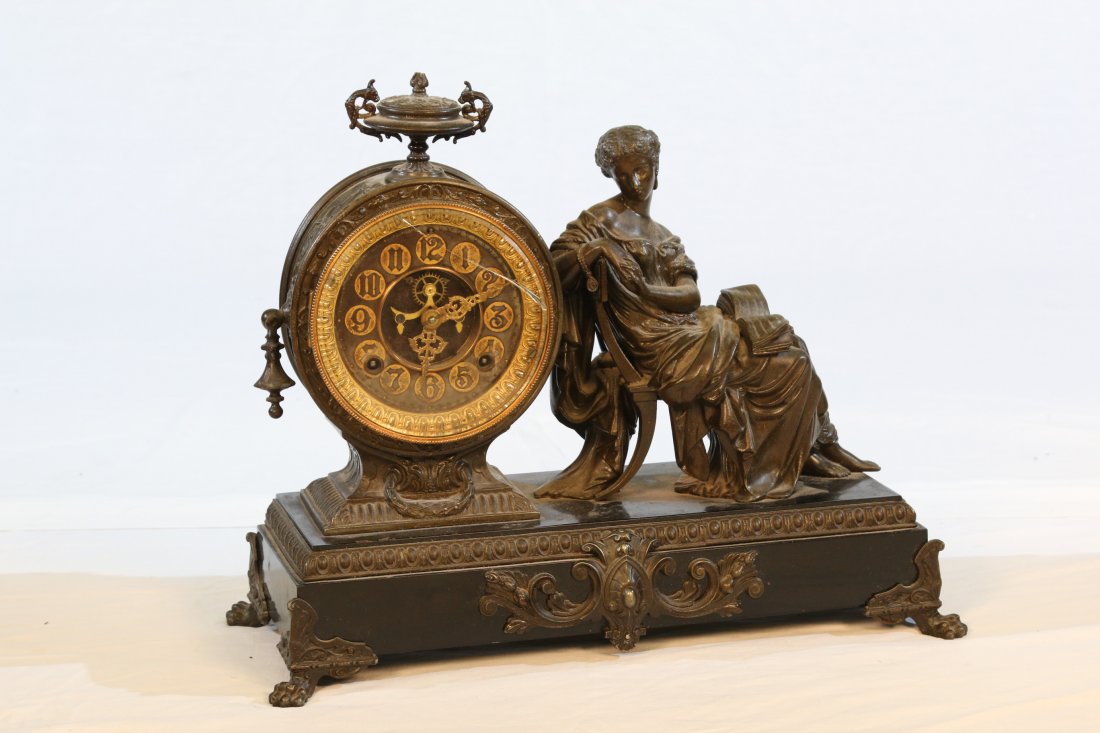 Clock: Ansonia works, marble base with statue figure, clock glass racked, top tip of finial chipped, back door appears to have been replaced