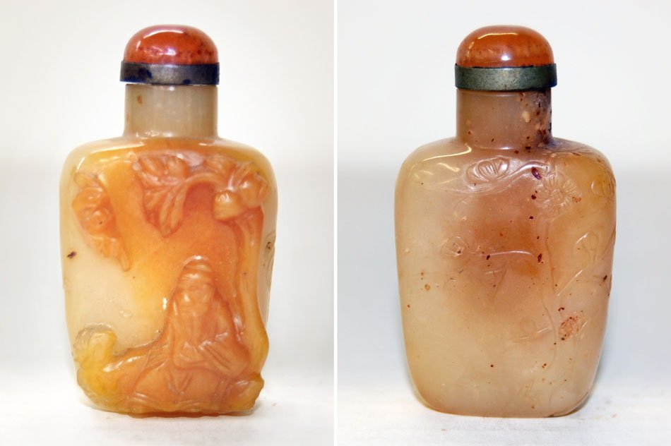 Chinese Republic Carved Stone Snuff Bottle: Chinese Republic (1912-49) or later carved stone snuff bottle of flattened square-shouldered form with russet cabochon cap in a brass collar, high-relief scene of a scholar sitting beneath a shelterin