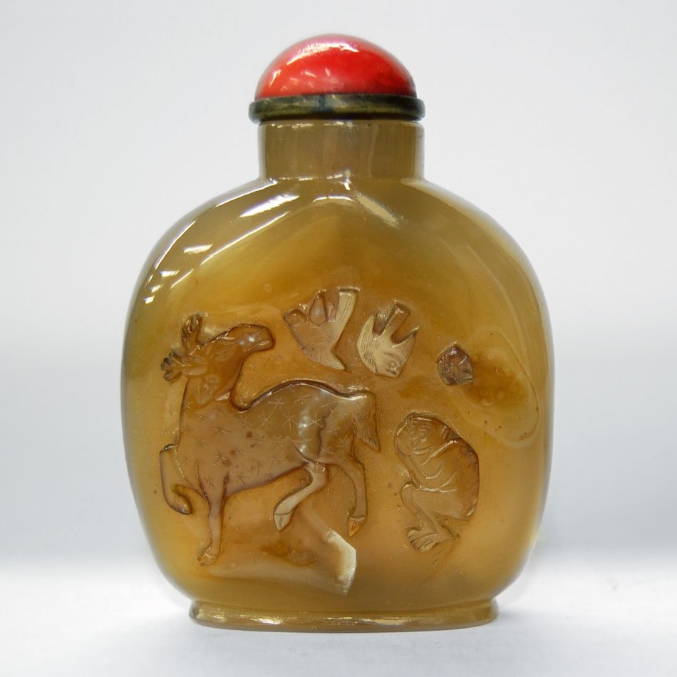 Chinese Republic Carved Chalcedony Snuff Bottle: Fine Chinese Republic-era carved chalcedony snuff bottle with bronze and red stone or glass cap. Auspicious animal motif to sides of deer, monkey and birds in mating flight. Early 20th century