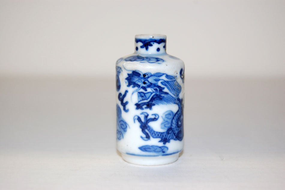Qing Chinese Blue & White Snuff Bottle: Very good late Qing Chinese underglaze blue and white small cylindrical snuff bottle. Motif of dragon amidst clouds. The base with apocryphal mark of the Qing Yongzheng reign. Mark L 19th Century