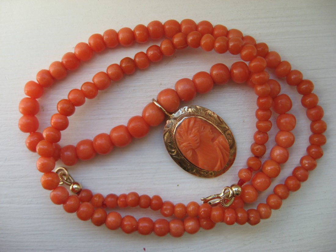 Vintage Carved Coral cameo Necklace 10K Gold: Vintage coral cameo necklace, 16.25" long. the beads graduated from 5 mm to 3mm, with 10K gold clasp, the hand carved coral cameo mounted in nice engraved 10K gold frame.