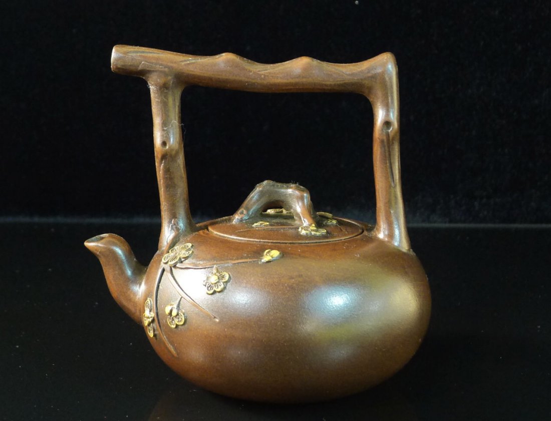 Chinese Yixing Clay Teapot: Chinese Yixing Clay Teapot with plum flower design, and a seal mark on the bottom, 4.75" x 5" x 4".