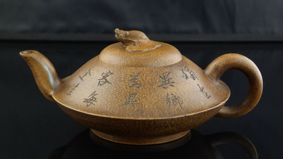 Chinese Yixing Clay Teapot: Chinese Yixing Clay Teapot with animal design, and a seal mark on the bottom, 3.5" x 7.5" x 5.5".