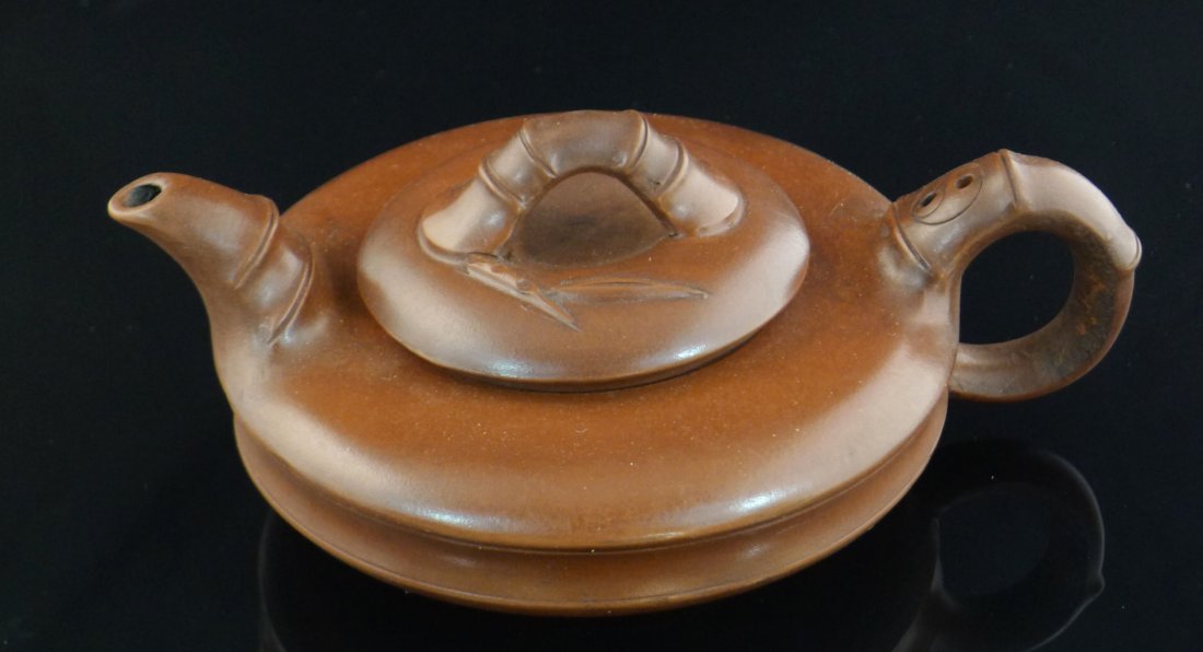 Chinese Yixing Clay Teapot: Chinese Yixing Clay Teapot with bamboo design, and a seal mark on the bottom, 2.8" x 7.25" x 5.25".