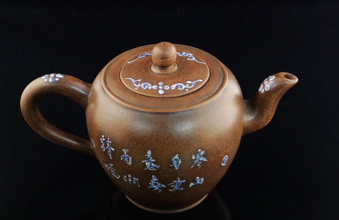 Chinese Yixing Clay Teapot: Chinese Yixing Clay Teapot with landscape design, and a seal mark on the bottom, 4.5" x 7.5" x 4.5".