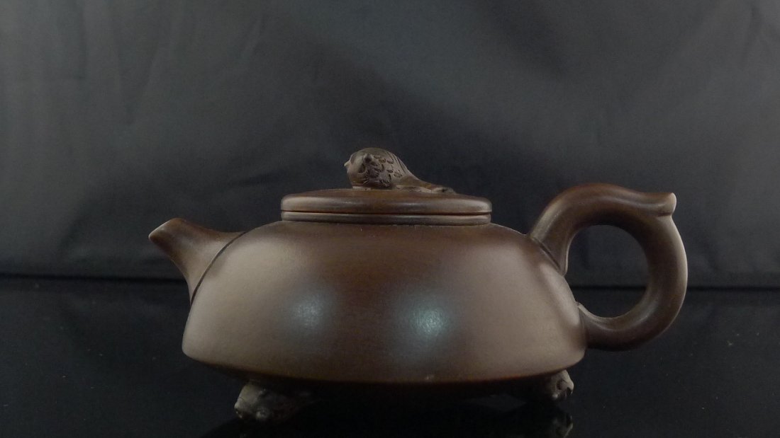 Chinese Yixing Clay Teapot: Chinese Yixing Clay Teapot with golden fish design, there is one inside of teapot and one on the cover, also 3 of the fishes with seal mark on the bottom, 4" x 7" x 3.5".