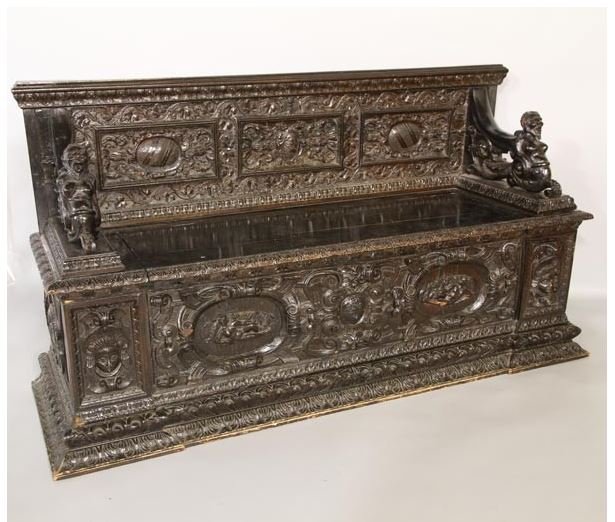 ANTIQUE ITALIAN CARVED BENCH: Antique Italian, ornately carved bench, figure head arms, coat of arms crest, lift top seat with storage below, 37"h x 66"w x 21"d.