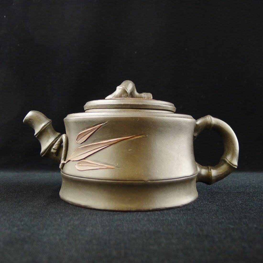 CHINESE YIXING CLAY TEAPOT: Chinese Yixing Clay Teapot with bamboo design, and a seal mark on the bottom, 4" x 7" x 4".