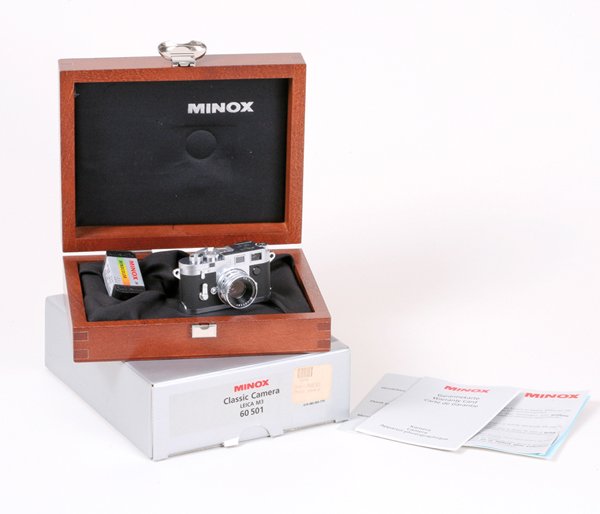 Minox Leica M3 Miniature in display case Nr. E02999.: Minox Leica M3 Nr. E02999 Miniature in wooden display case, with original box, & a roll of film.
