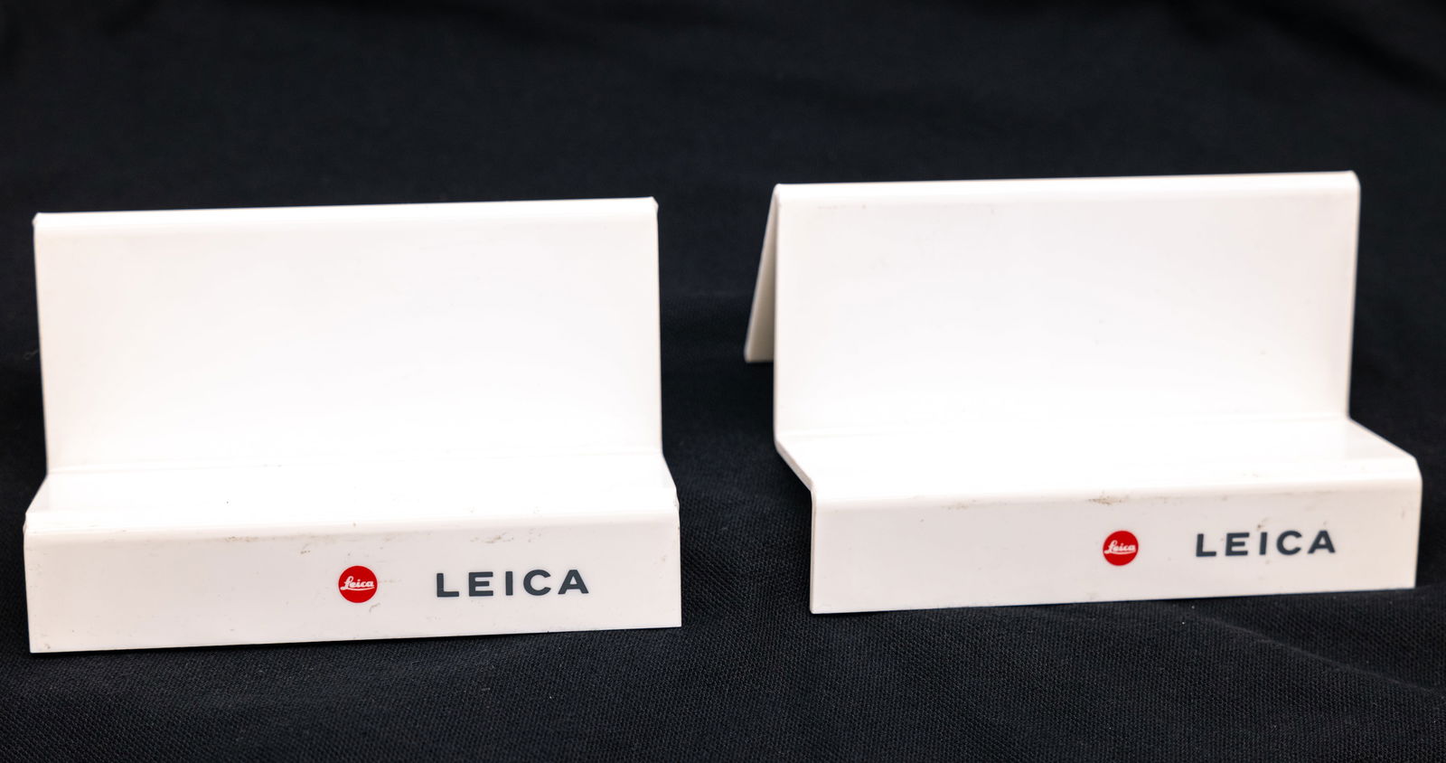 Two Leica Red Dot white plastic camera stands (1 of 4)
