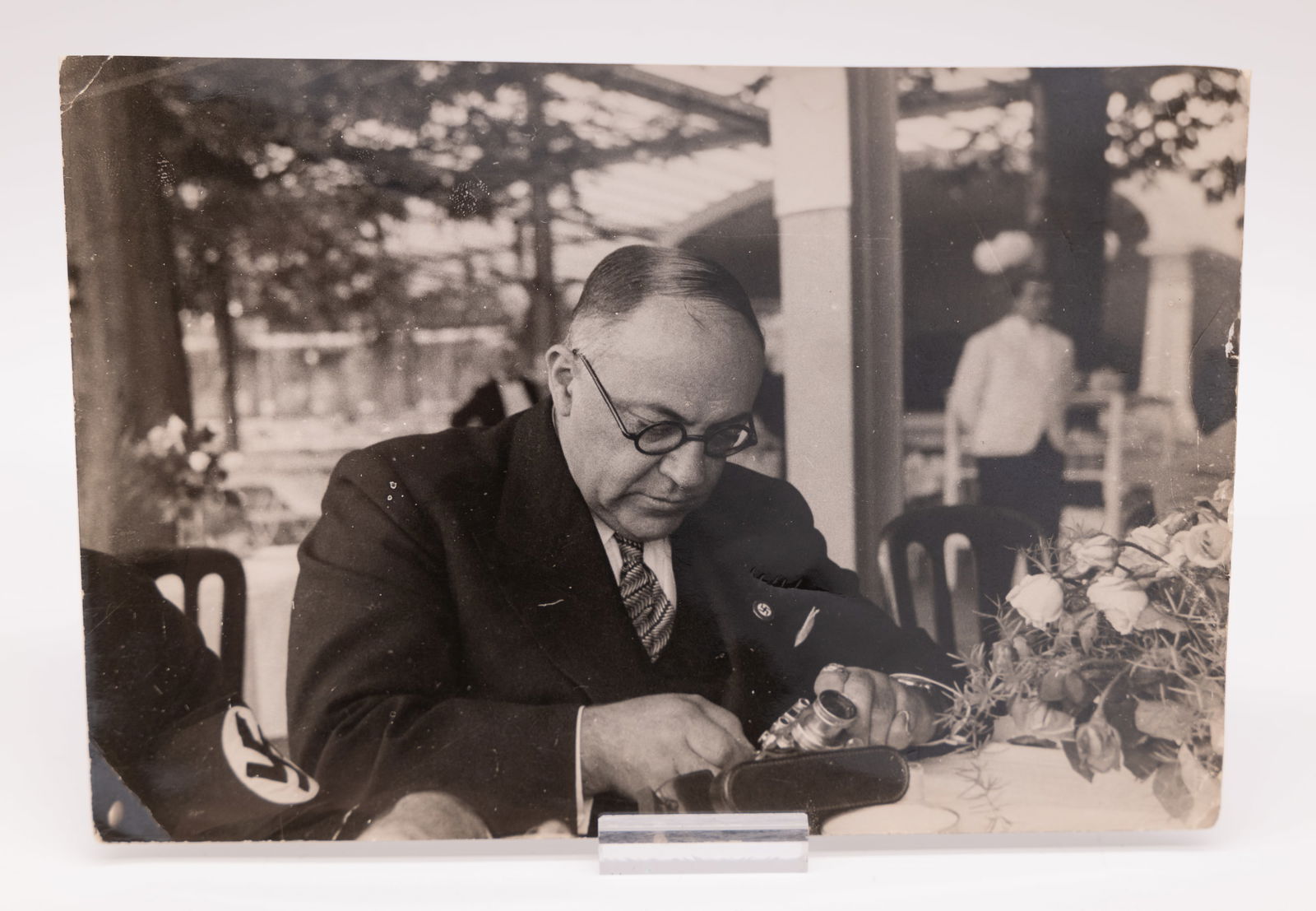 Photograph of Dr. Theodor Morrell, by Heinrich Hoffmann: Photograph of Dr. Theodor Morrell, by Heinrich Hoffmann. This 5x7-inch original photo shows Adolph Hitler’s personal physician examining a Leica camera with 50mm Summar lens. The photograph is stamp