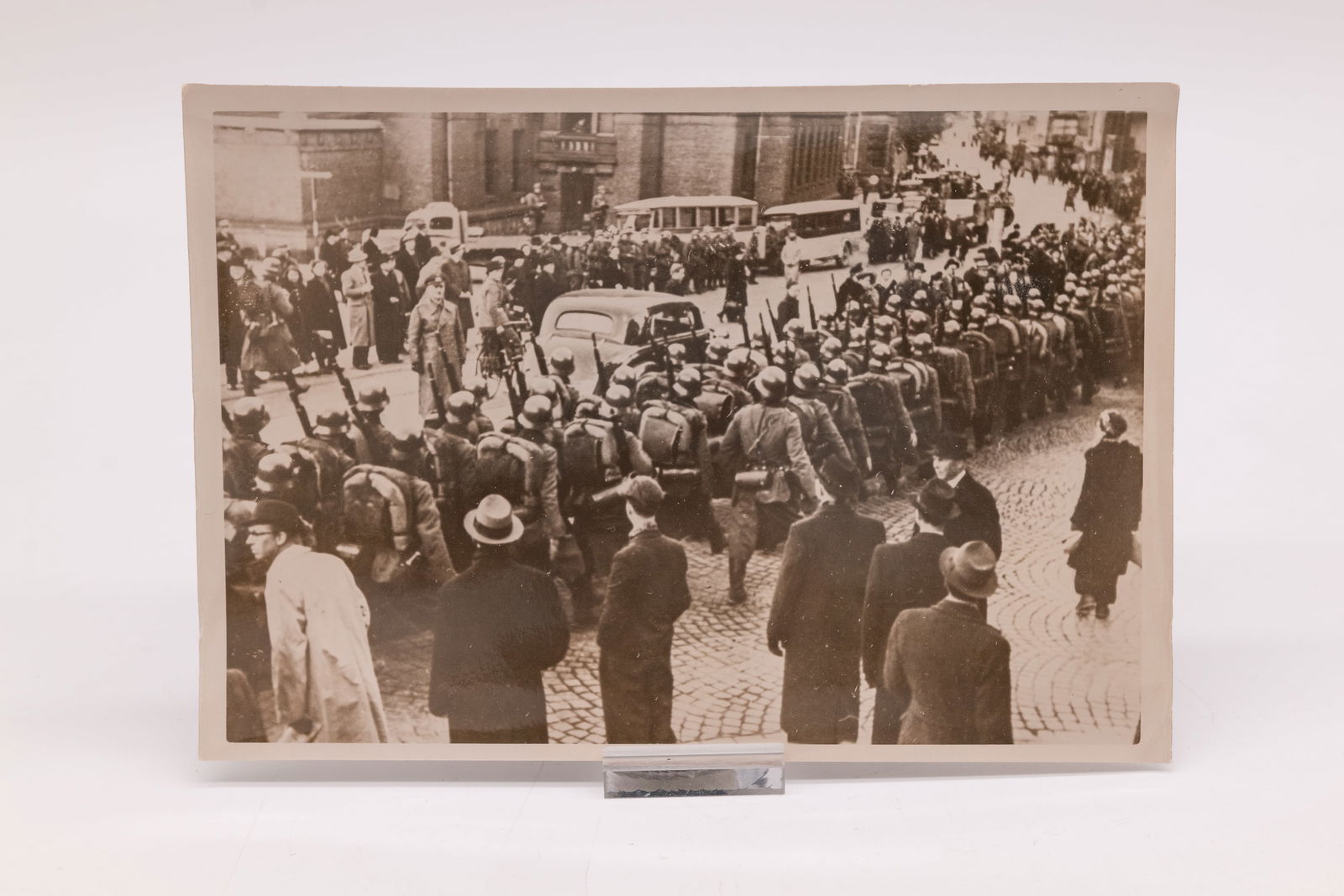 Three original photographs by Heinrich Hoffmann: Three original photographs by Heinrich Hoffmann, showing scenes from 1940, including parades. These 5x7-inch and 4x6-inch photos bear Hoffmann's studio's oval stamp en verso. Condition: Excellent + ov