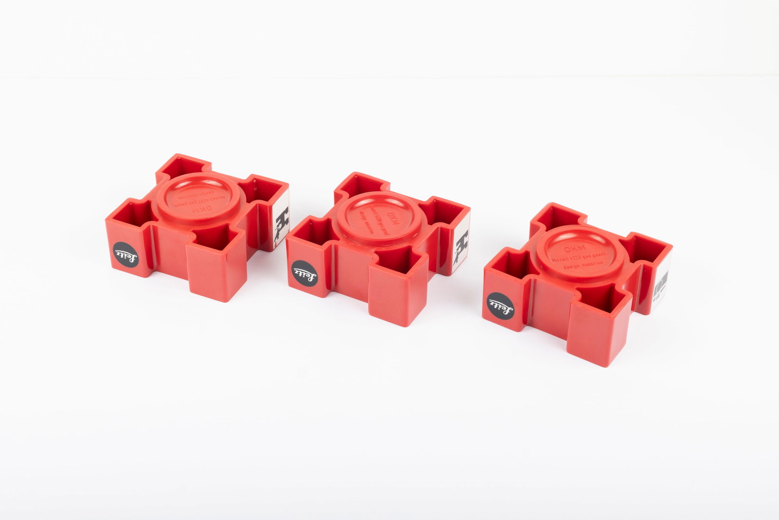 Three Leitz red plastic lens display stands - 3