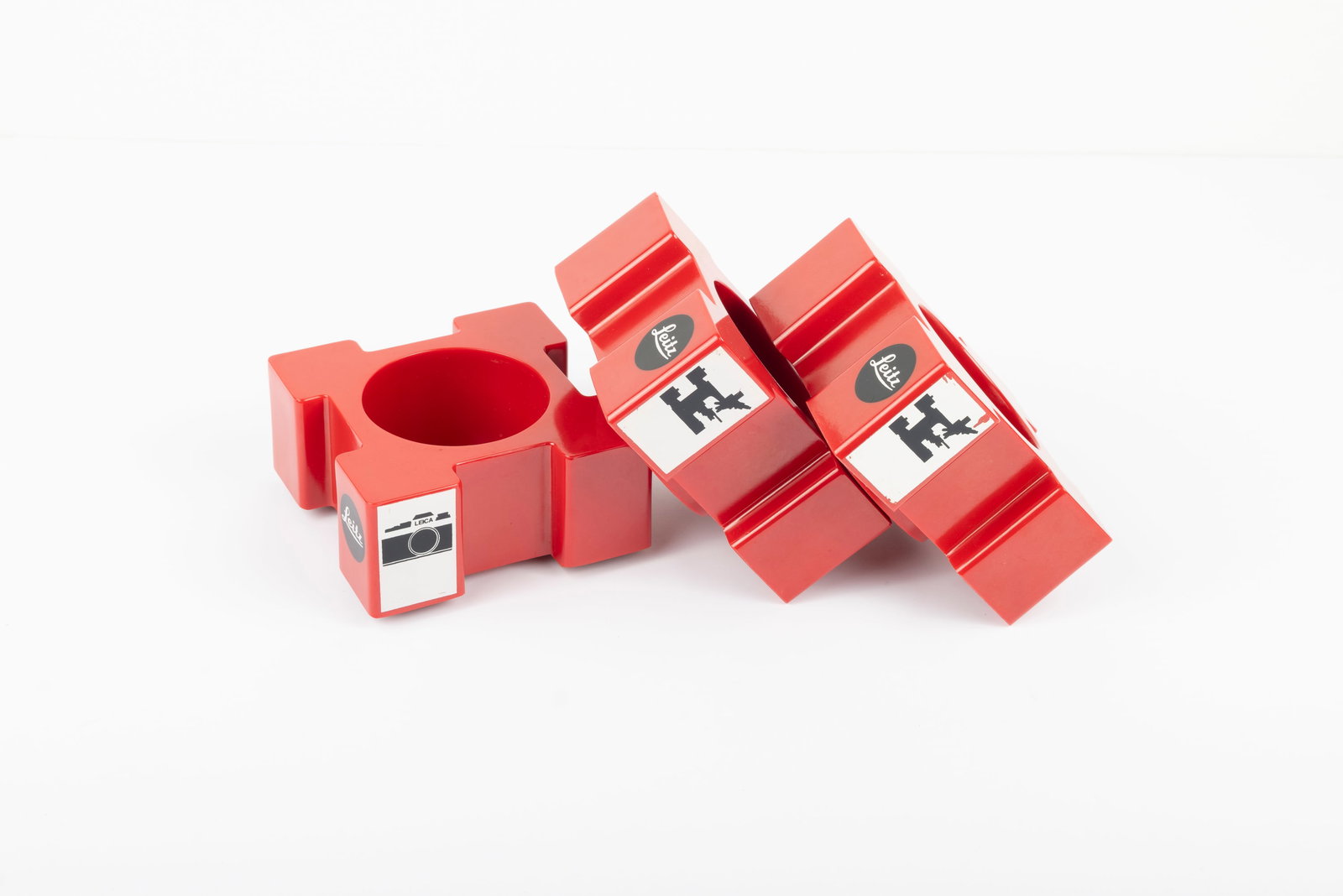 Three Leitz red plastic lens display stands - 4