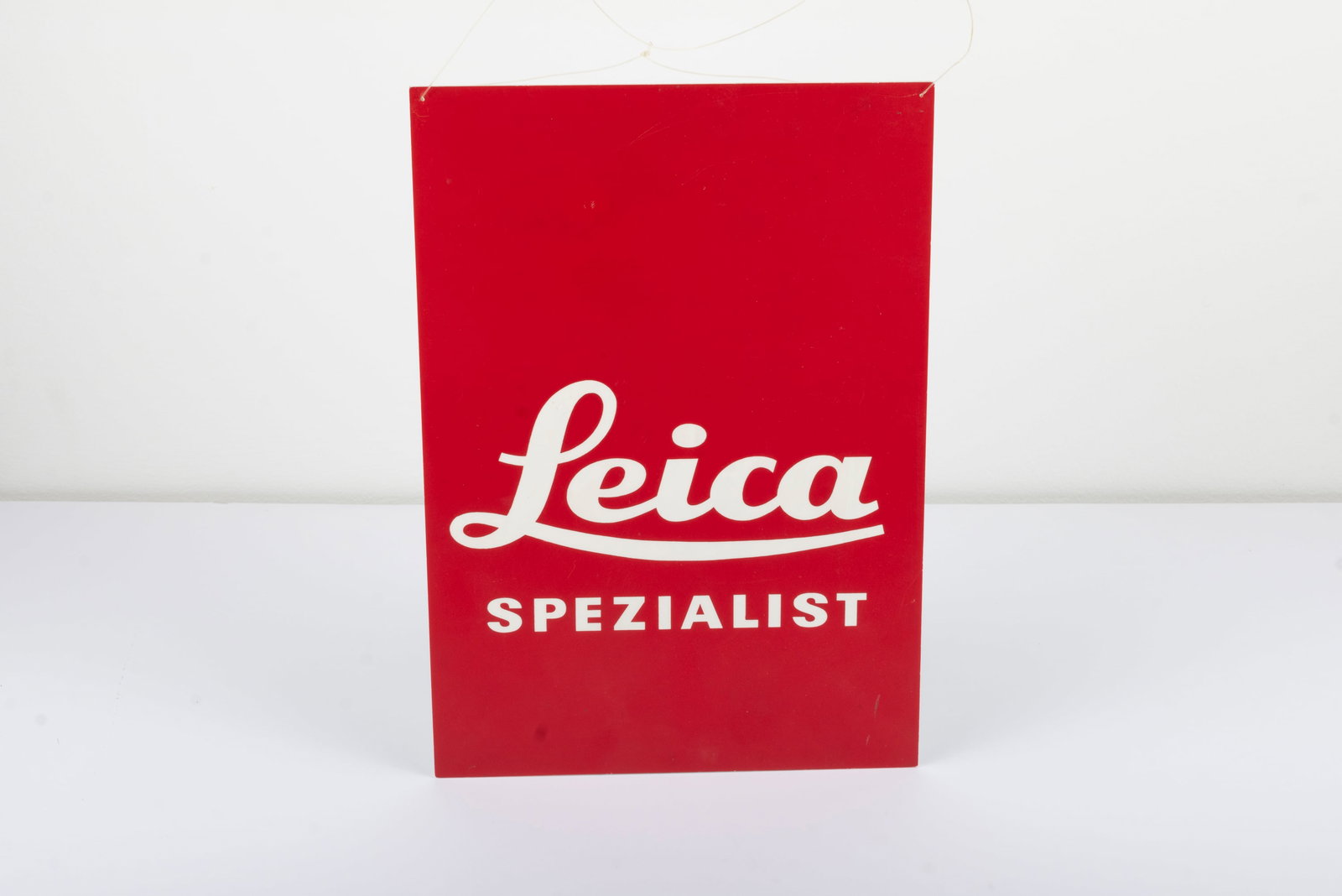 "Leica Spezialist" plastic dealer sign: "Leica Spezialist" plastic dealer sign, measuring approximately 11 1/2" by 8"Condition: Excellent +