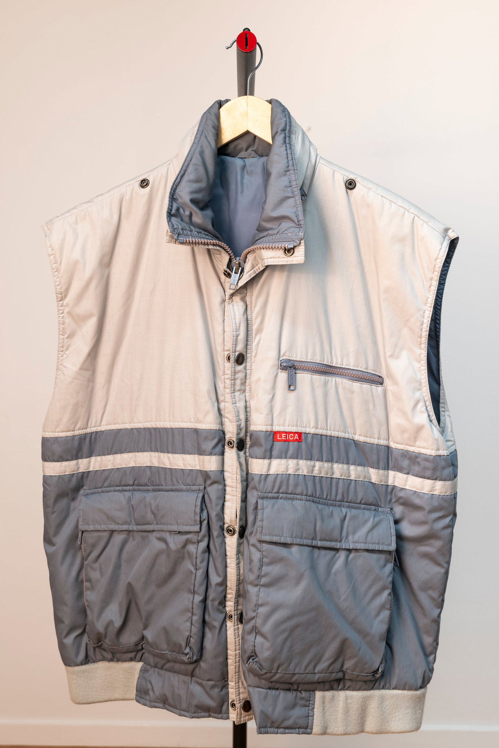 Blue-Grey Photographer's Vest: Blue-Grey Photographer's Vest in "XL" size, with "LEICA" brand lettering on chest and on the zipper pulls. The length is 26", the chest 52" and the back width dimension is 22". With inner zipper Napol