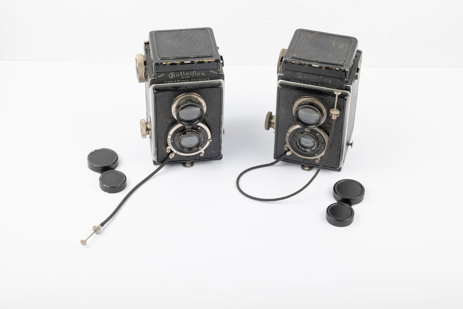 A Pair of Original Rolleiflex cameras: A Pair of Original Rolleiflex cameras. Rolleiflex 4,5 Original Nr. 67133 and Rolleiflex 3,8 Original Nr. 41059, with lens caps and cable releases. The 3,8 camera bears the seller's placard.Condition: