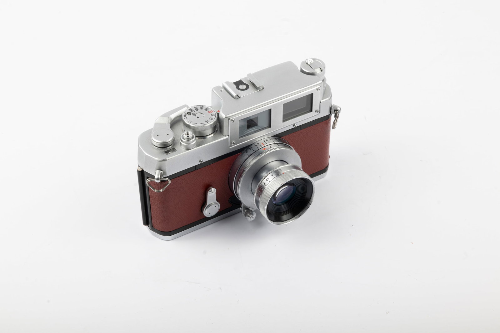 Yasuhara T981: Yasuhara T981 camera covered in red leatherette, without serial number or markings. Introduced in 1998 and made until 2001, these adept little rangefinder cameras feature an exposure meter and a top