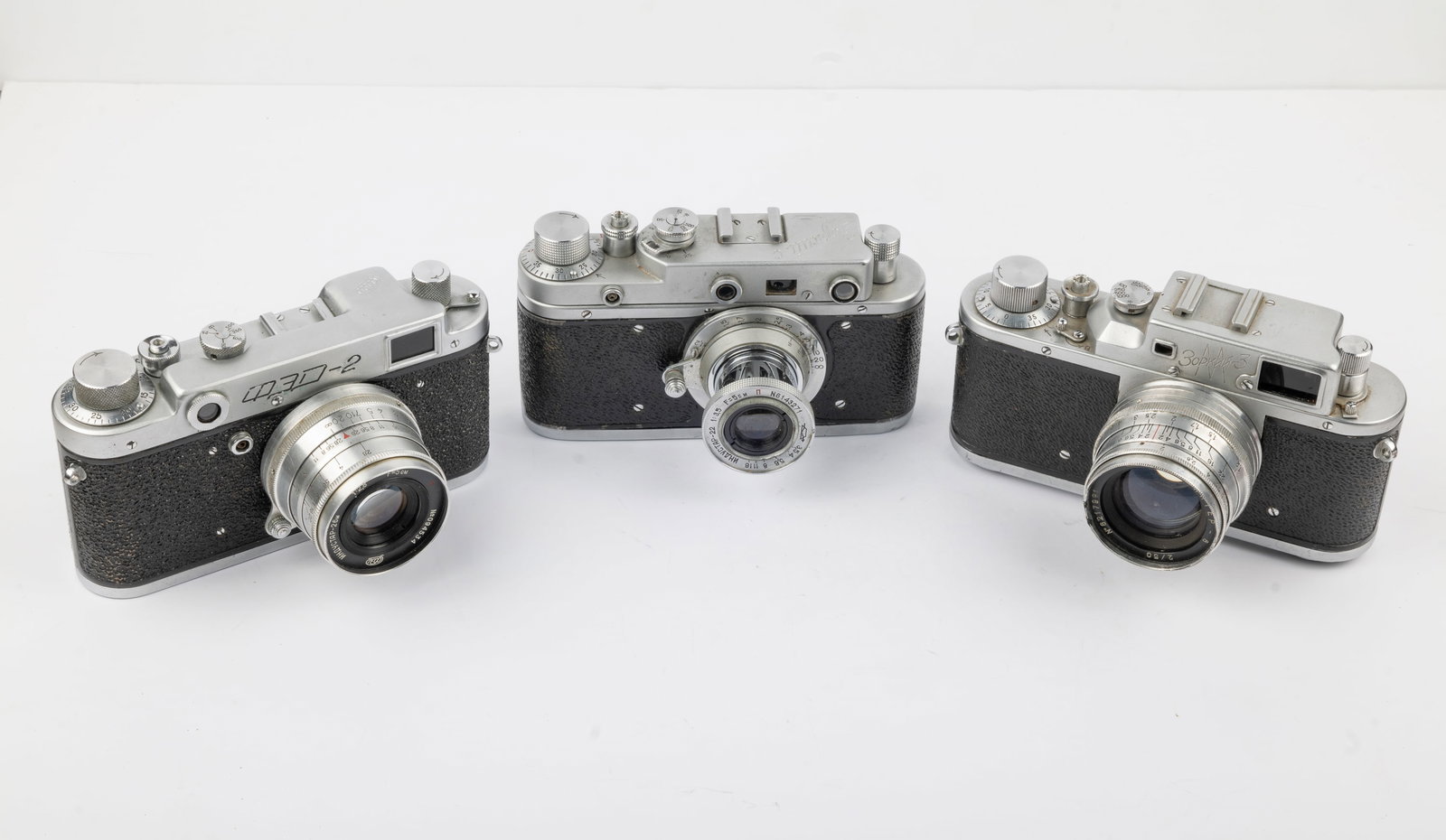 Three Russian-made rangefinder cameras: Three Russian-made rangefinder cameras with 50mm lenses:FED-2 Nr. 321744, Zorki C Nr. 56013653, and Krasnogorsk Zorki 3 Nr. 5554206.Condition: Very good overall