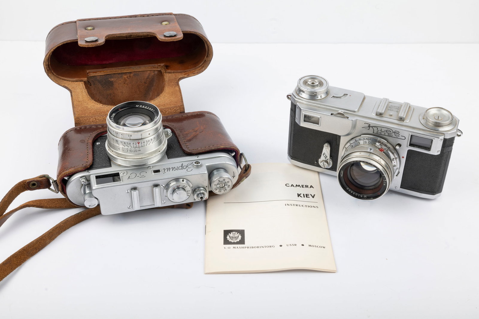Two Russian rangefinder cameras "Made in the USSR": Two Russian rangefinder cameras "Made in the USSR": Kiev 4A Nr. 533870 with 50mm Jupiter-8 f2 lens Nr. 5305999 and original English- and Russian-language instructions booklet. With Zorki 3C Nr. 562212