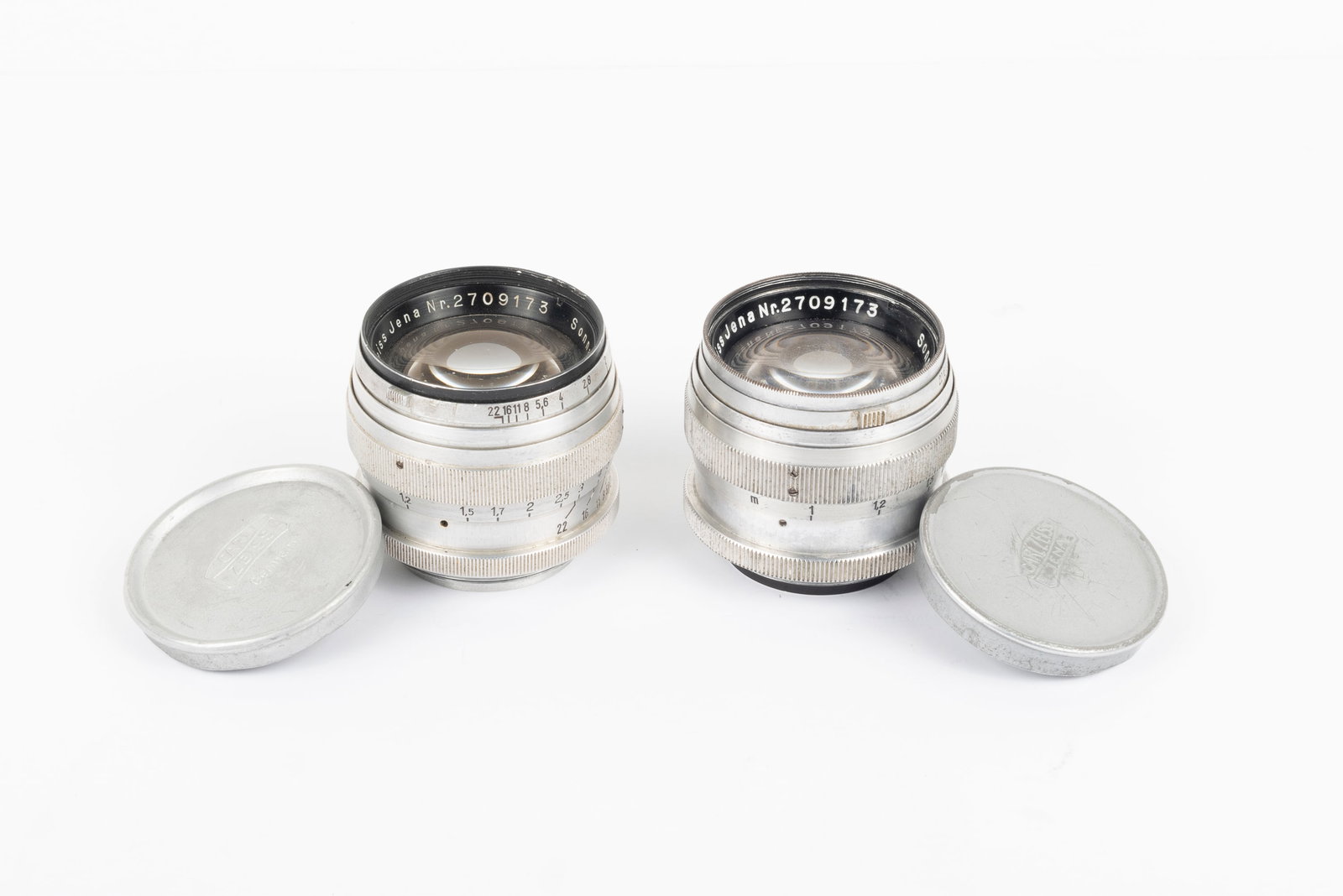 A pair of 50mm Sonnar lenses same serial number: A pair of 50mm Sonnar lenses in Leica screw mount. Rarely seen, these two Zeiss Jena 50mm Sonnar lenses share a serial number: 2709173. While the front ring engravings differ slightly, both lenses wer