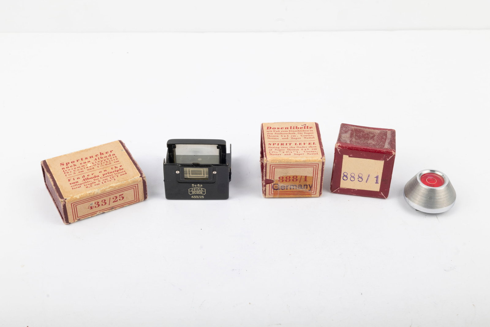 Two Zeiss Ikon optical accessories: Two Zeiss Ikon optical accessories: Spirit Level 888/1 in its box, and Sports Finder 433/25 also in its box. This black finish folding Albada Viewfinder has become increasingly hard to find.